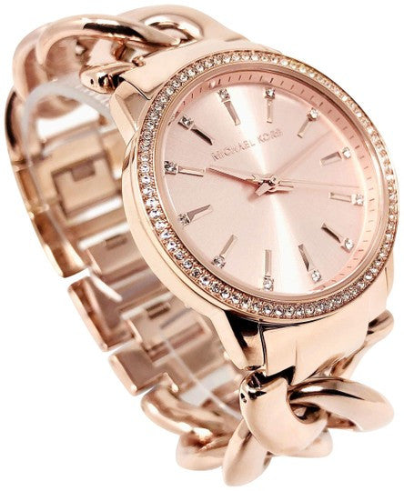 Michael Kors Nini watch angled view showing rose gold twisted chain bracelet and crystal bezel