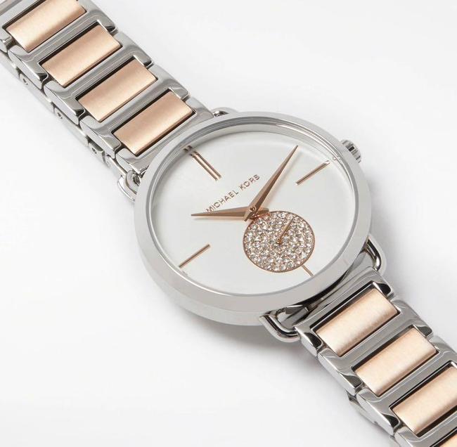 Michael Kors Portia watch angled view showing two-tone silver and rose gold bracelet