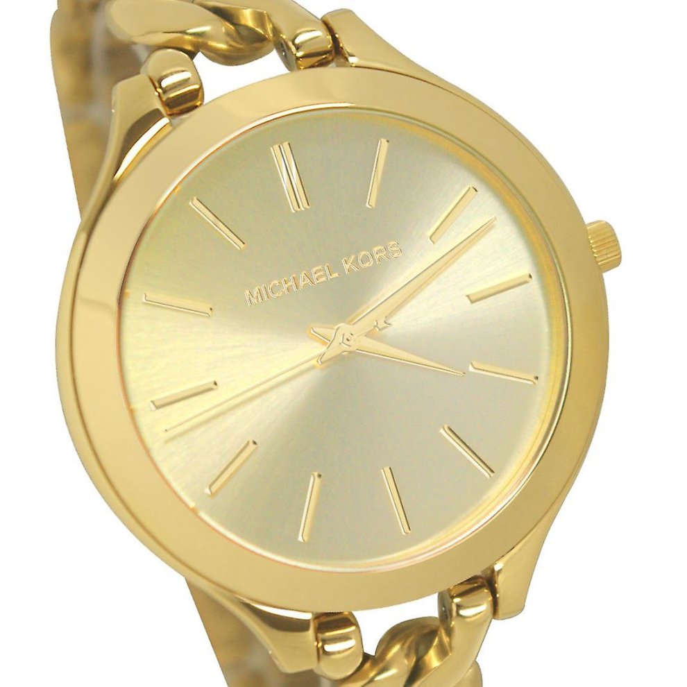 Close-up of champagne dial with Michael Kors branding and gold hour markers