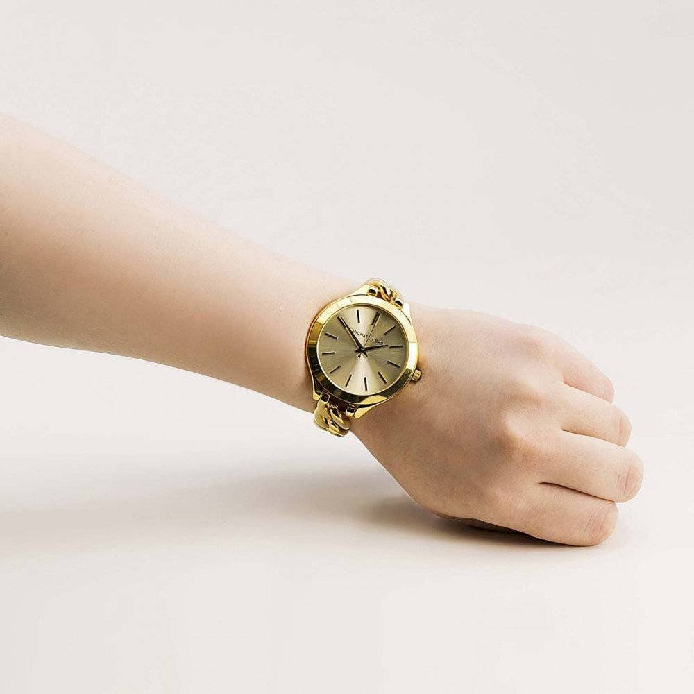 Michael Kors Slim Runway gold watch displayed on wrist from side angle