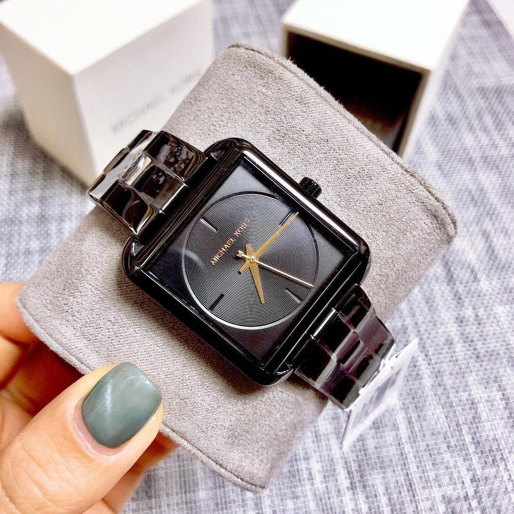 Michael Kors Square Lake black tone watch worn on wrist with black metal bracelet