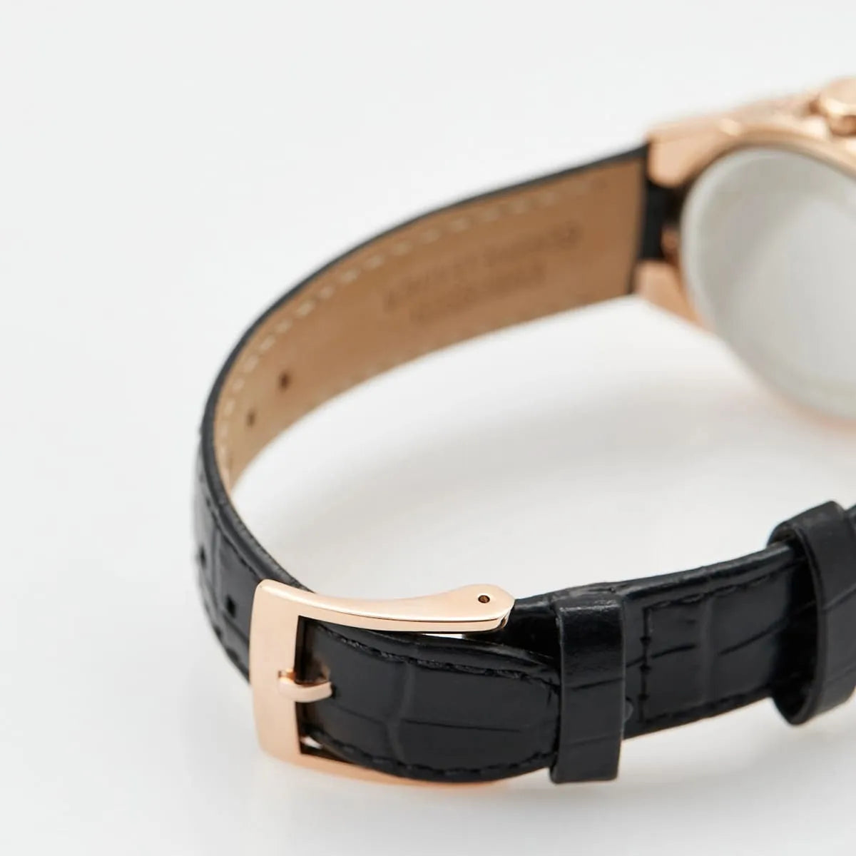 Close-up of Michael Kors Mini Camille black crocodile-embossed leather strap with rose gold buckle and clasp