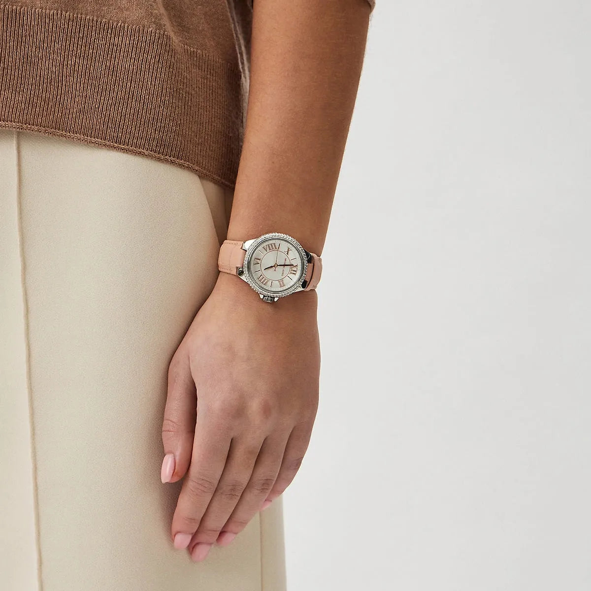 Michael Kors Camille watch worn on wrist showing white dial and crystal bezel detail