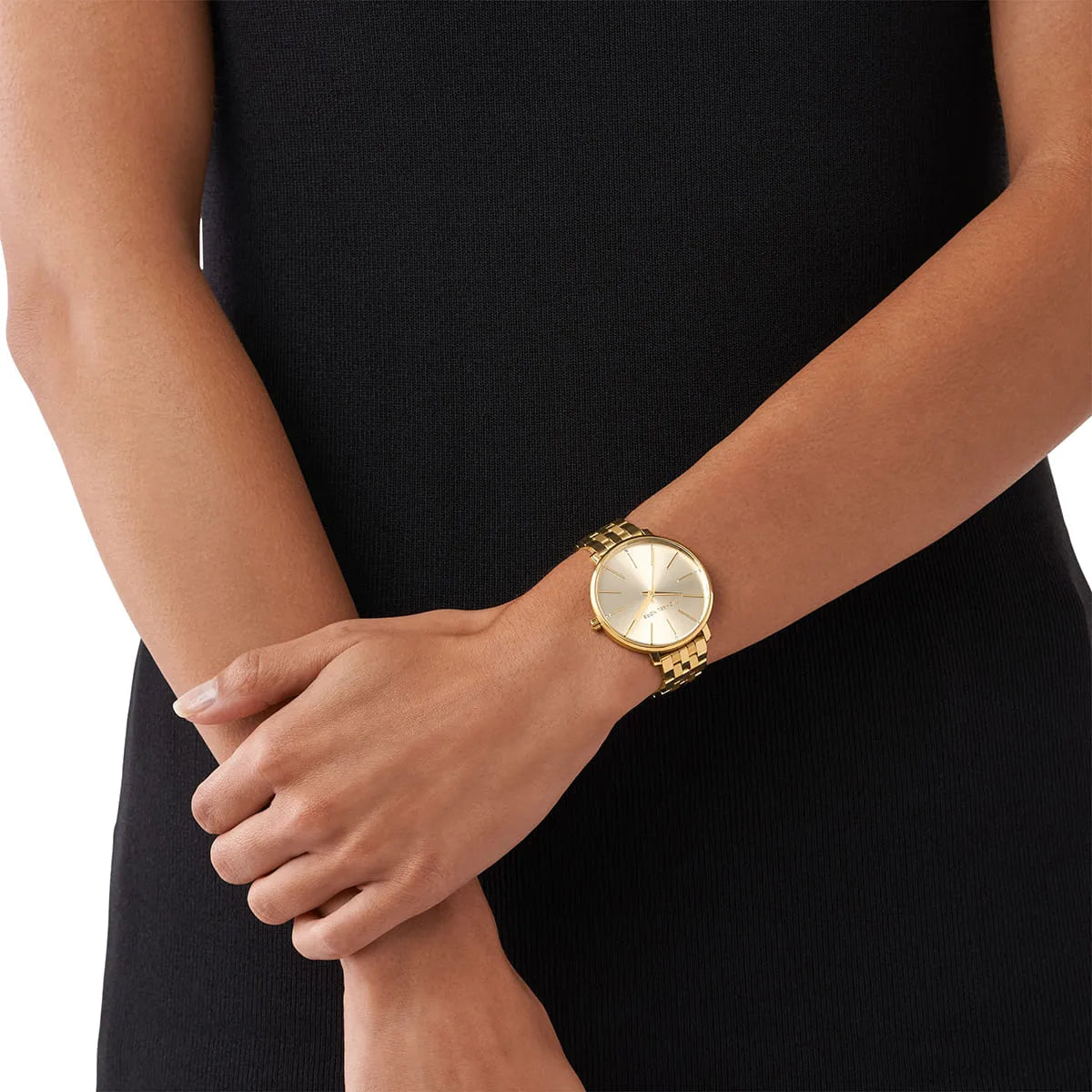 Michael Kors Pyper gold-tone watch worn on wrist with champagne dial