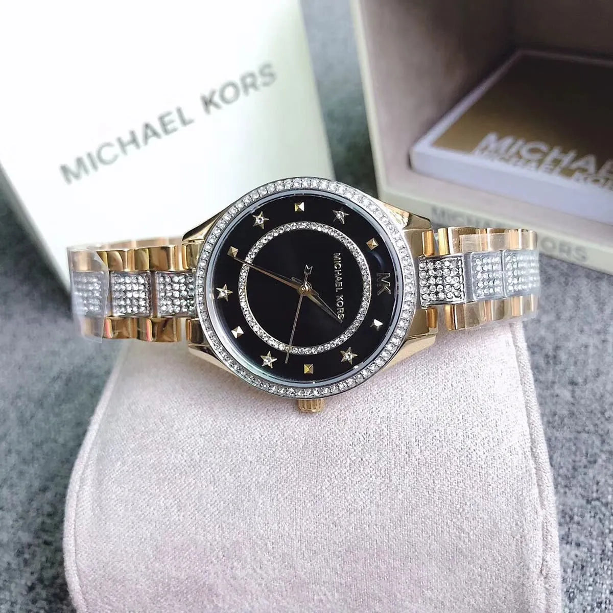 Michael Kors Lauryn watch worn on wrist showing black dial and two-tone crystal strap