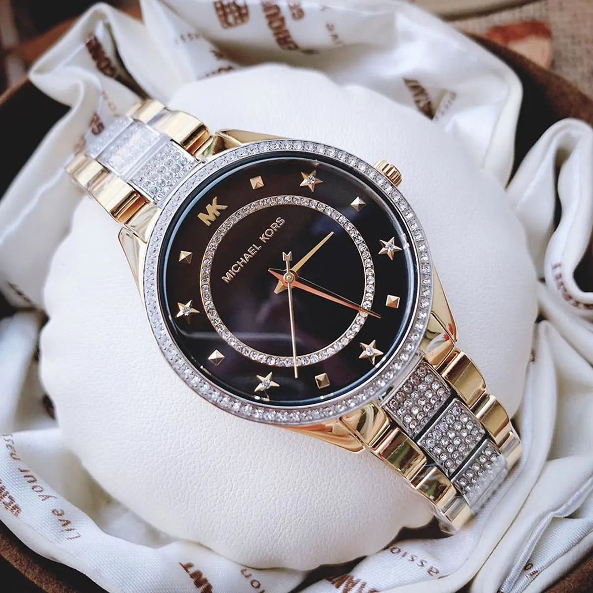 Michael Kors Lauryn watch on wrist displaying star-marked black dial and two-tone case