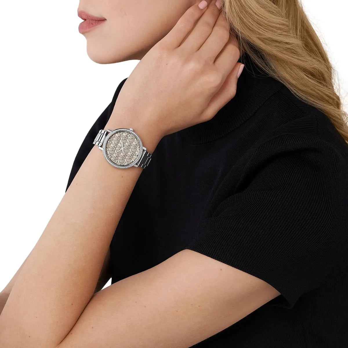 Michael Kors Pyper watch worn on wrist showing grey dial with MK pattern and crystal bezel detail