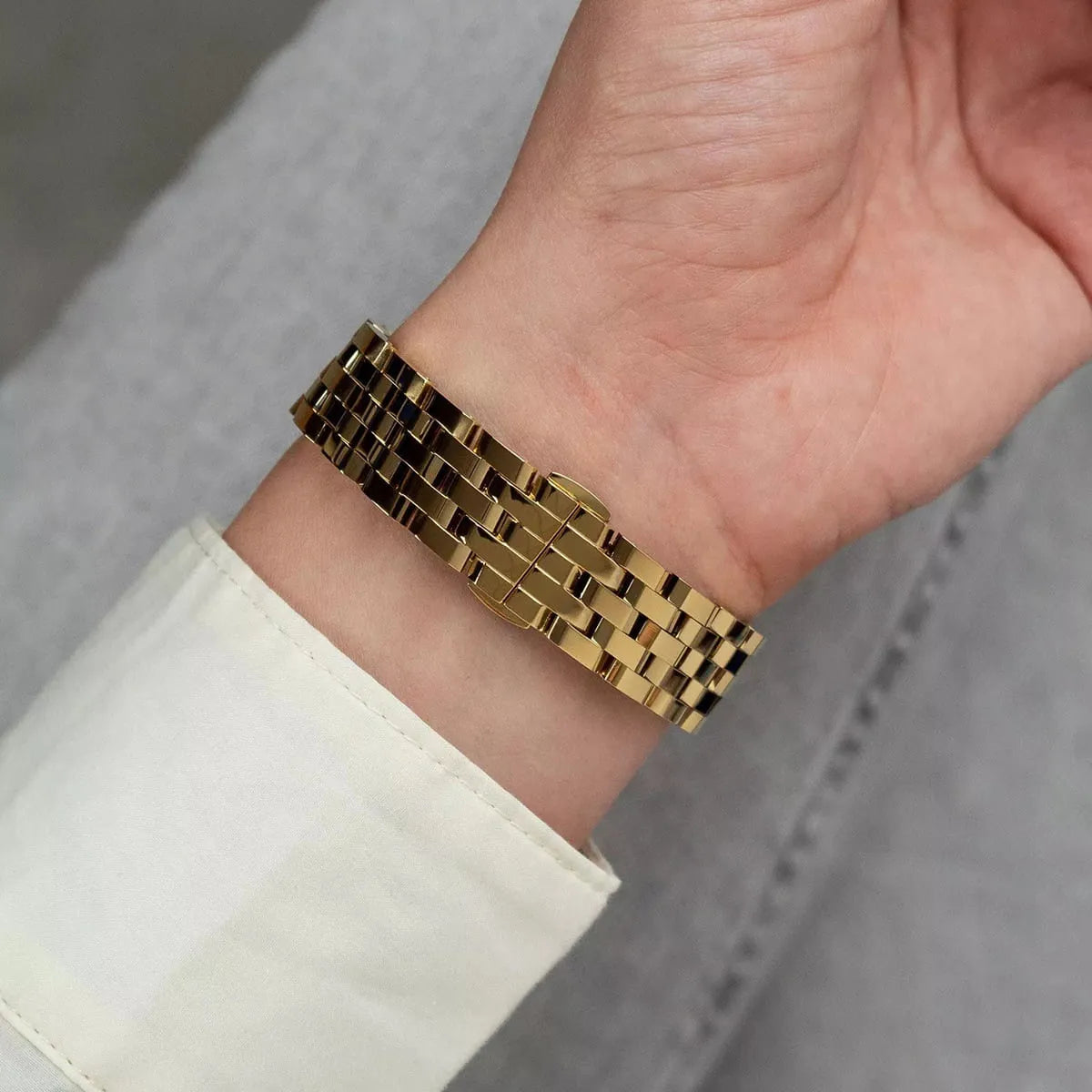 Michael Kors Georgie women's gold watch on wrist showing bracelet side view