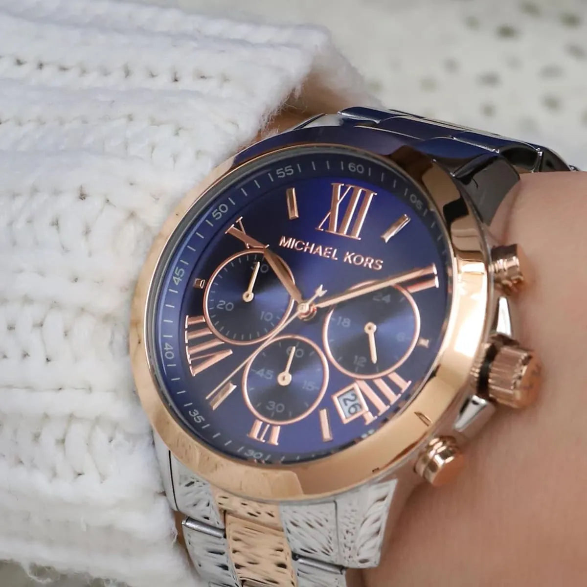 Michael Kors Bradshaw chronograph watch on wrist with blue dial and rose gold bezel