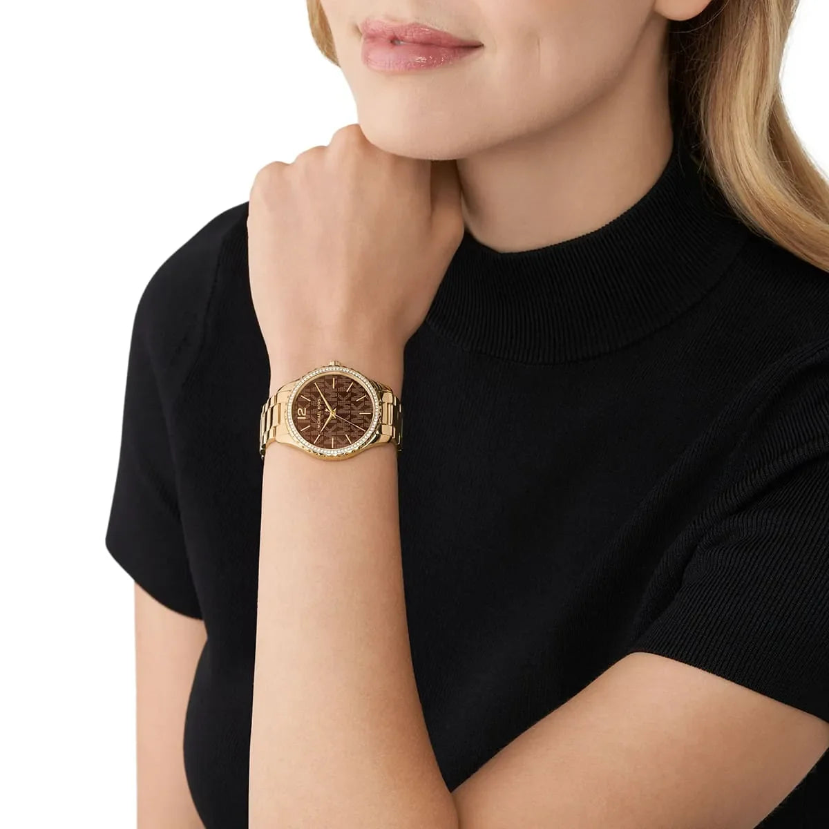 Michael Kors Oversized Lennox Pavé watch worn on wrist with brown dial and gold-tone bracelet