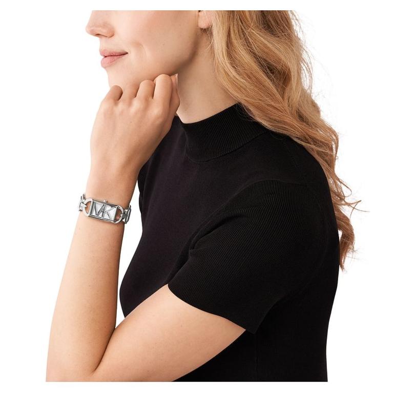 Michael Kors Mini Empire rectangular silver watch worn on wrist