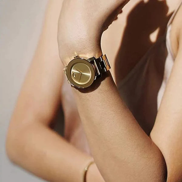Movado Bold gold watch worn on wrist showing dial and bracelet