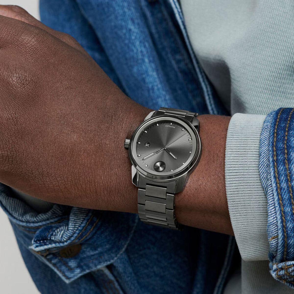Movado BOLD Verso gunmetal watch worn on wrist with dark dial and bracelet