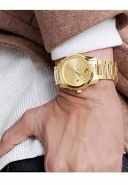 Movado BOLD Verso 42mm goldtone watch worn on wrist with dress shirt