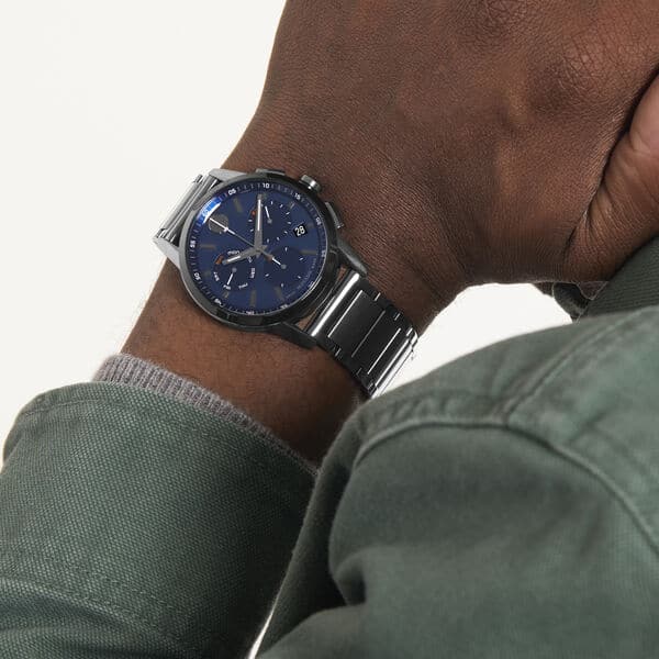 Movado Museum Sport Chronograph watch worn on wrist with blue dial and metal bracelet