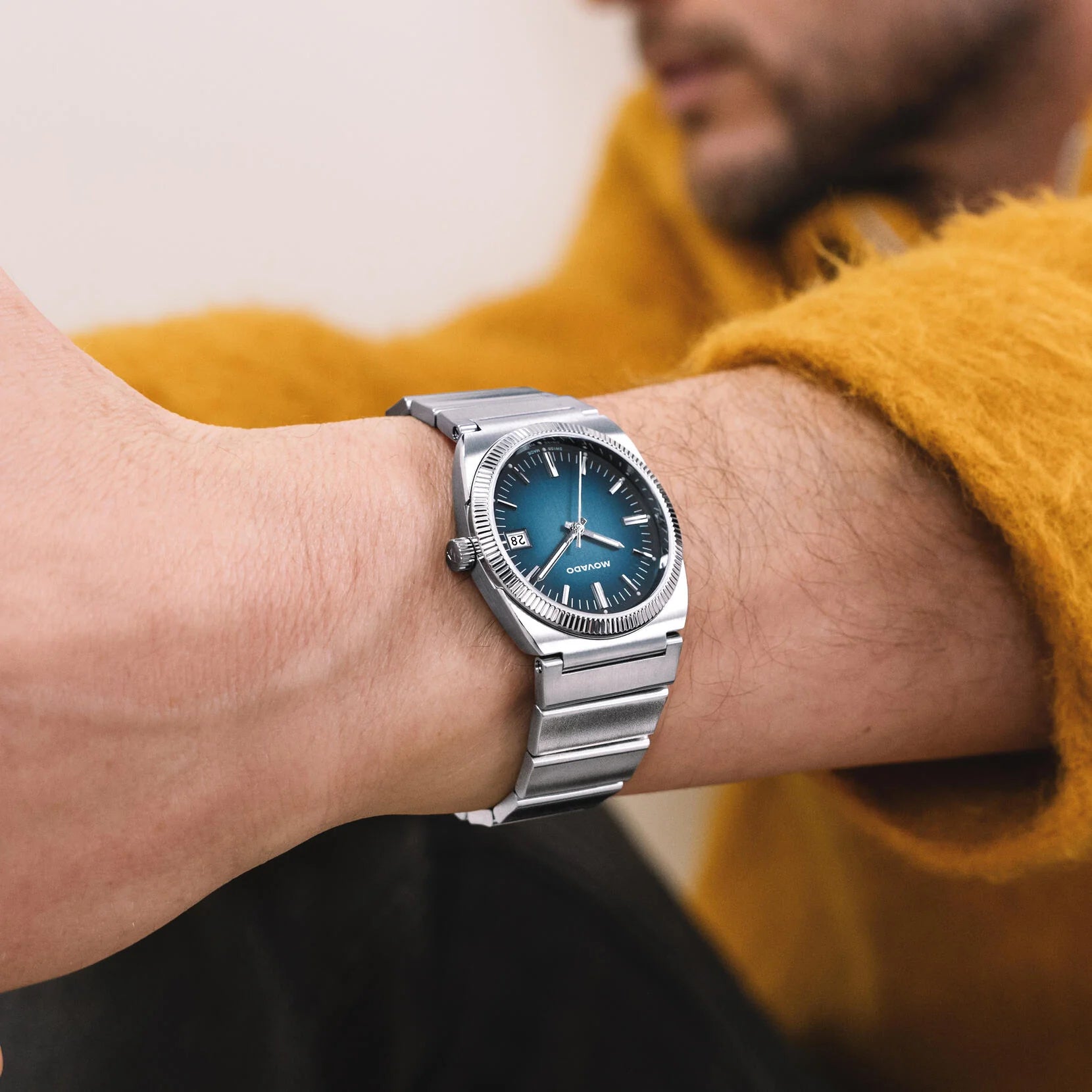 Movado Heritage Ondoplan watch worn on wrist with blue dial visible
