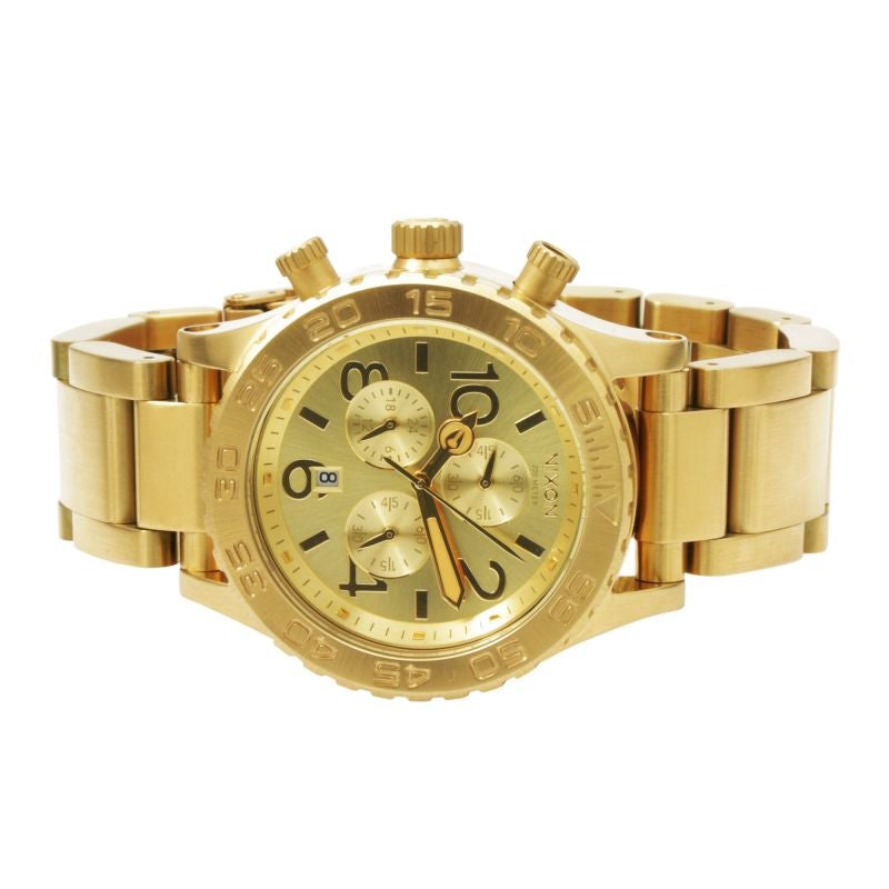 Gold-tone Nixon 42-20 Chrono watch at angle showing face and bracelet