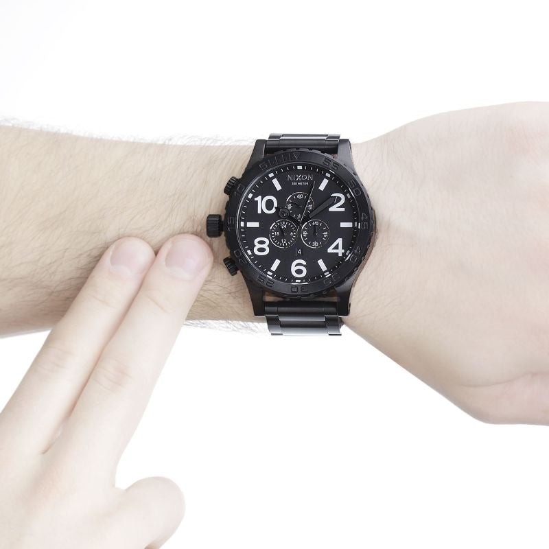 Nixon 51-30 Chrono all-black watch worn on wrist showing dial and band