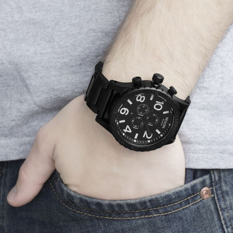 Nixon 51-30 Chrono black chronograph watch on wrist with black steel bracelet