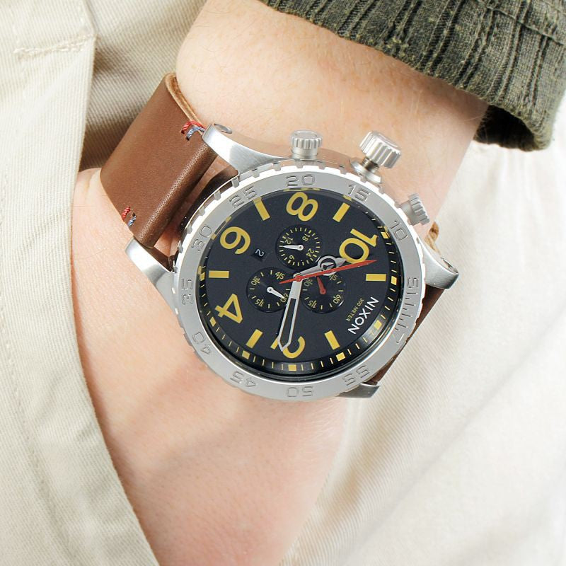 Nixon 51-30 Chrono worn on wrist with brown leather strap and stainless steel case detail