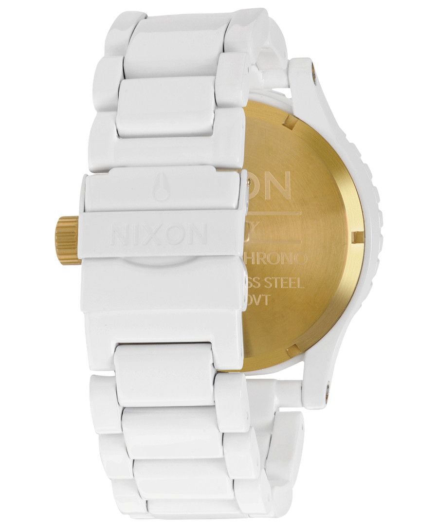 Caseback of Nixon 51-30 showing gold-plated case back and white bracelet links