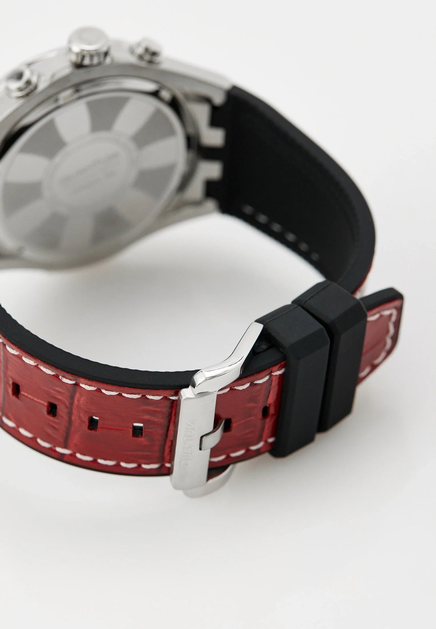 Quantum watch worn on wrist showing gunmetal dial and red silicon strap