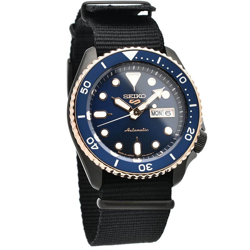 Seiko 5 Sports SBSA098 men's watch with blue bezel, black dial, and black fabric strap