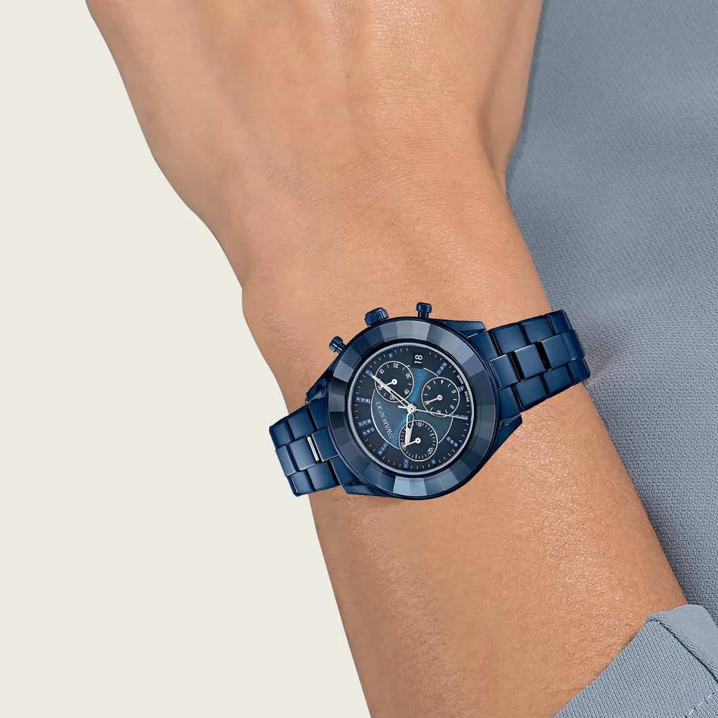 Swarovski blue metal chronograph watch worn on wrist