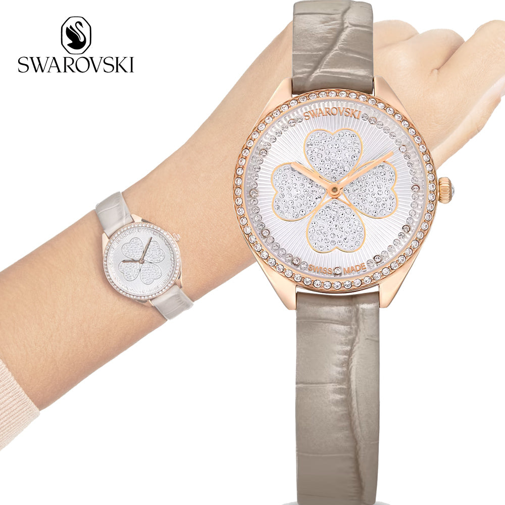 Swarovski Attract Clover watch shown in hand with brand logo and size comparison to smaller model
