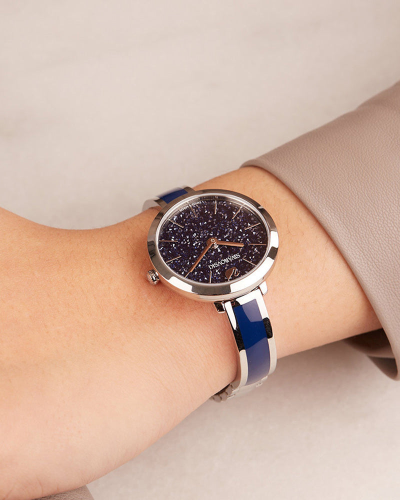 Swarovski Crystalline Delight women's watch worn on wrist with blue leather strap