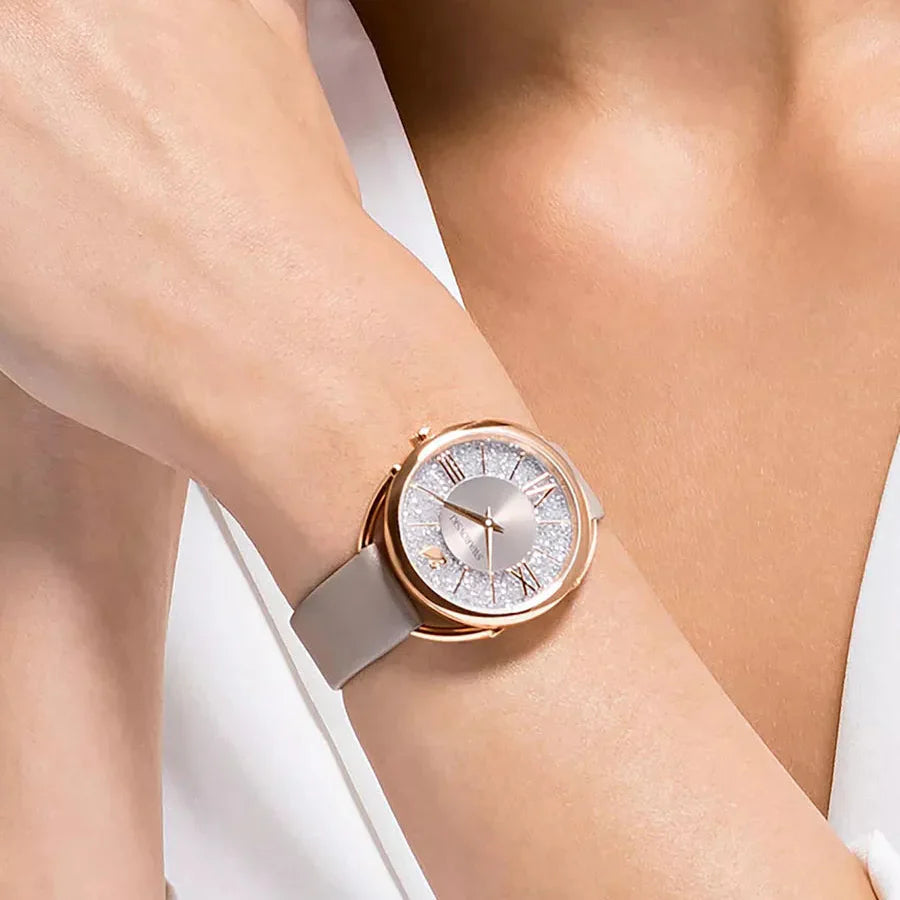 Crystalline Glam women's watch on wrist displaying crystal-encrusted bezel and grey leather band