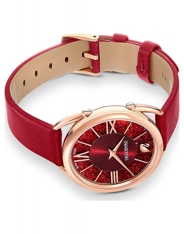 Swarovski Crystalline Glam watch on wrist showing red leather strap and rose gold case