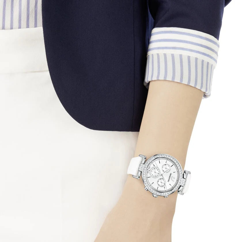 Swarovski Era Journey watch worn on wrist with silver dial and white leather strap