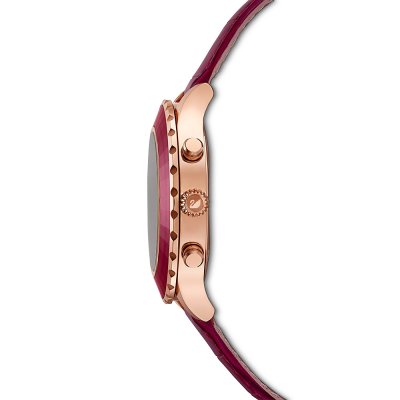 Side view of Swarovski watch showing rose-gold case, burgundy dial, and leather strap