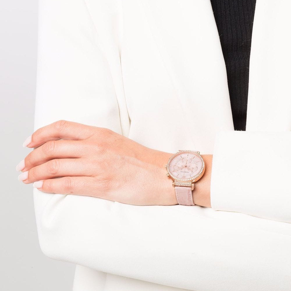 Swarovski Passage Chrono rose gold watch worn on wrist with pink leather strap