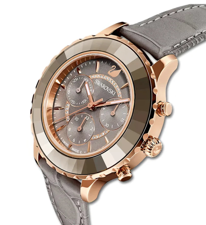 Swarovski Stella chronograph watch angle view showing rose gold case and gray leather strap