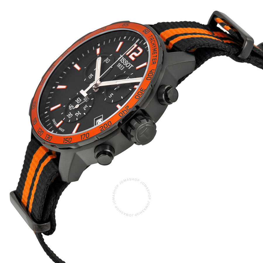 Angled view of Tissot Quickster showing chronograph pushers, orange bezel, and orange-striped nylon strap