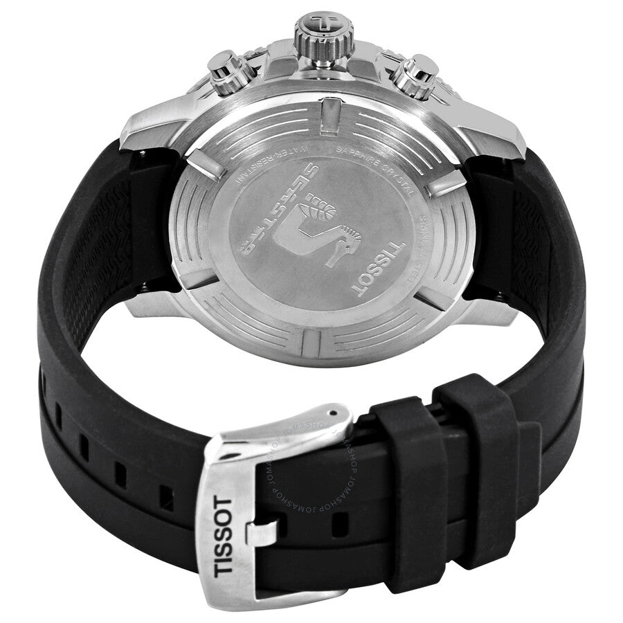 Transparent caseback view showing chronograph movement and Tissot branding on stainless steel case