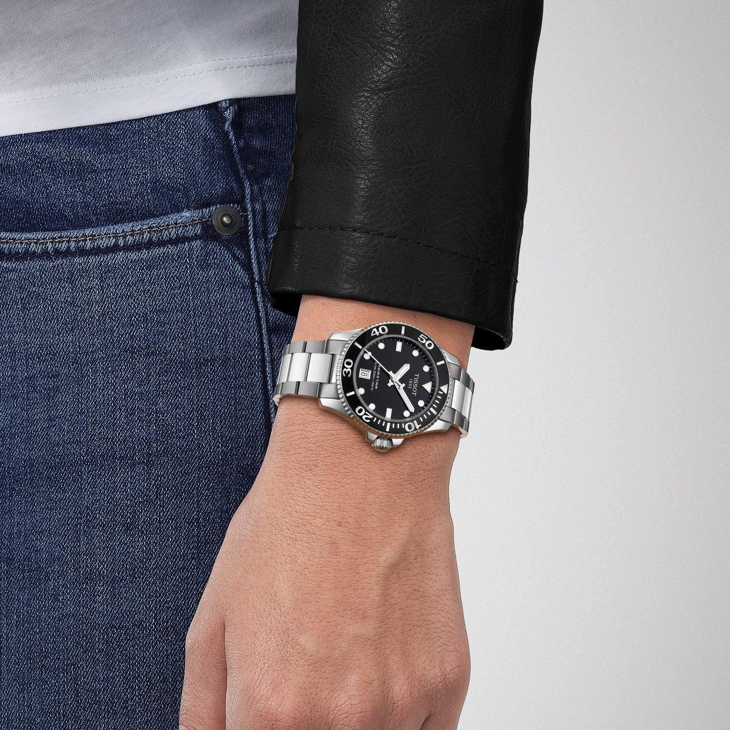 Tissot Seastar 1000 black dial watch worn on wrist with steel bracelet