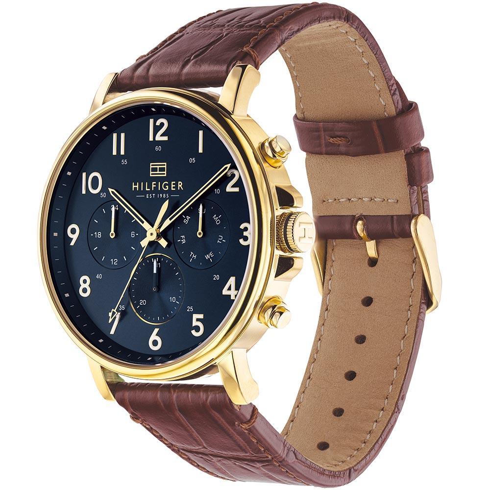 Side angle view of Tommy Hilfiger watch showing brown crocodile-pattern leather strap and gold-tone case