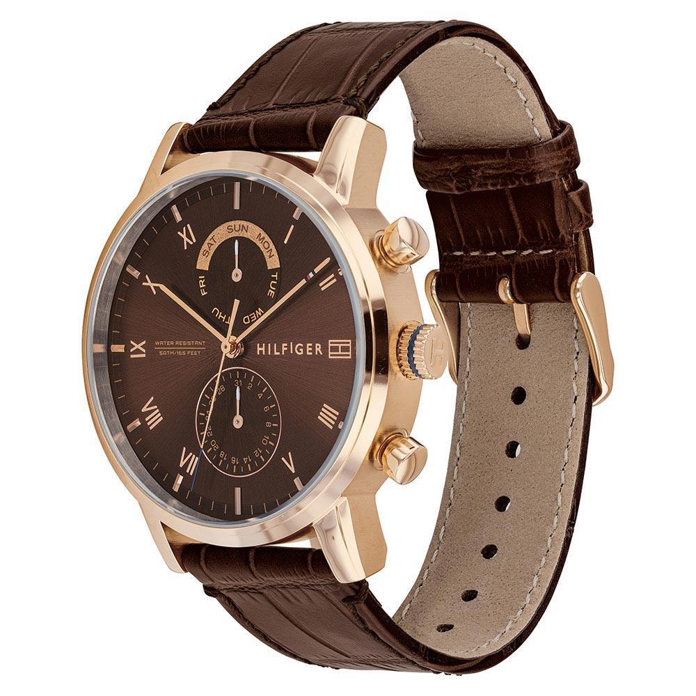 Side profile of Tommy Hilfiger chronograph watch showing brown leather strap and rose gold case lugs