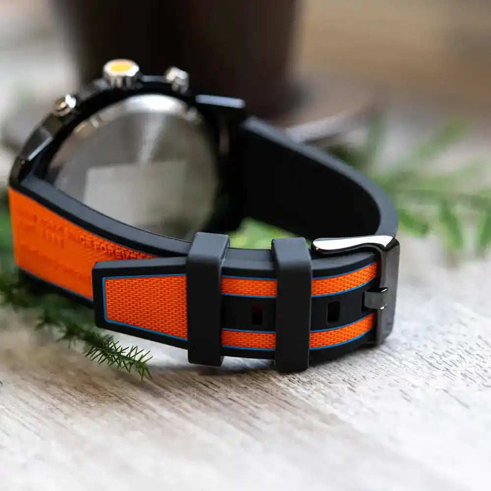 Tommy Hilfiger orange and black striped silicone strap with buckle closure on wrist