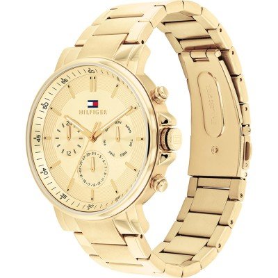 Gold Tommy Hilfiger chronograph watch shown from three-quarter view with matching gold bracelet