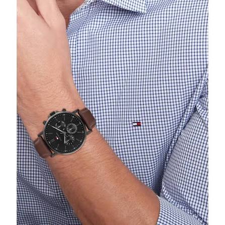 Tommy Hilfiger chronograph watch worn on wrist with dark brown leather strap