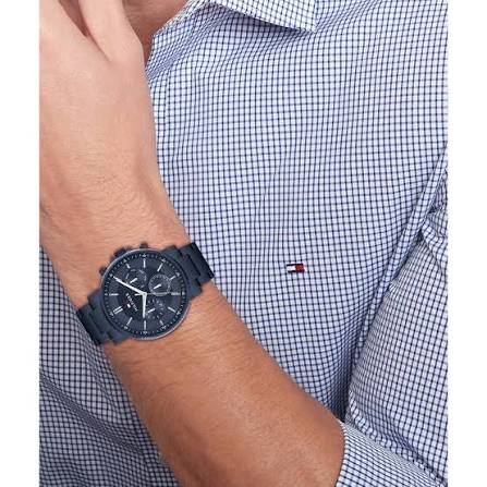 Tommy Hilfiger steel blue chronograph watch worn on wrist with checkered shirt