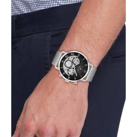Tommy Hilfiger watch with stainless steel mesh strap worn on wrist