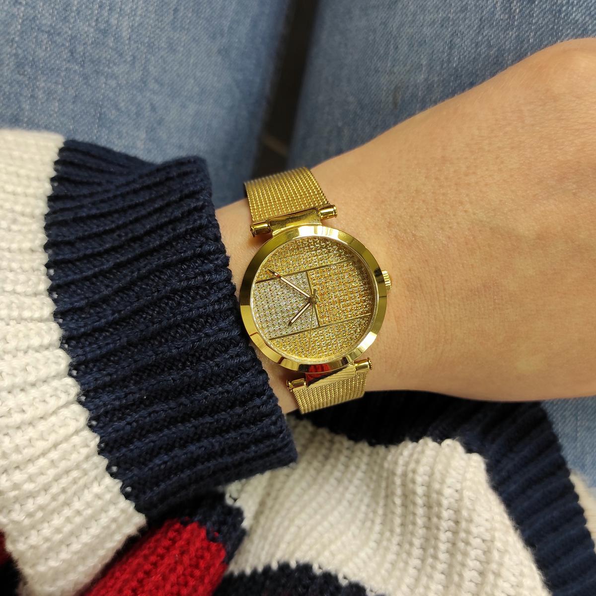 Tommy Hilfiger women's quartz watch on wrist styled with dark sweater