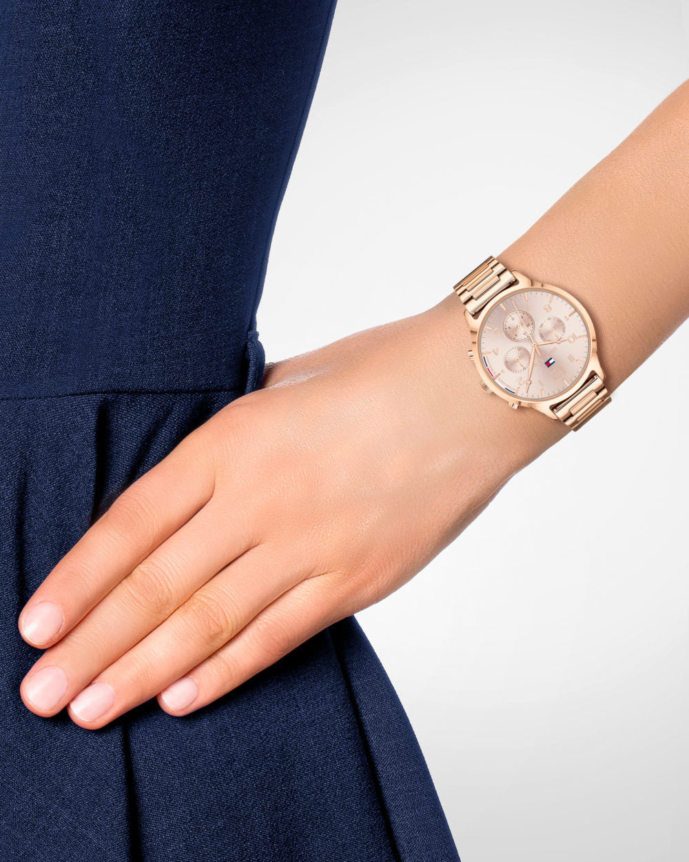 Tommy Hilfiger women's watch worn on wrist with pink dial and rose gold case