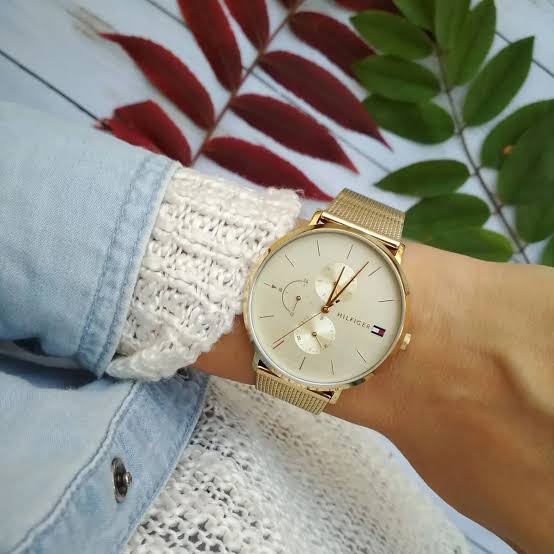 Tommy Hilfiger 1781943 gold watch worn on wrist with mesh strap