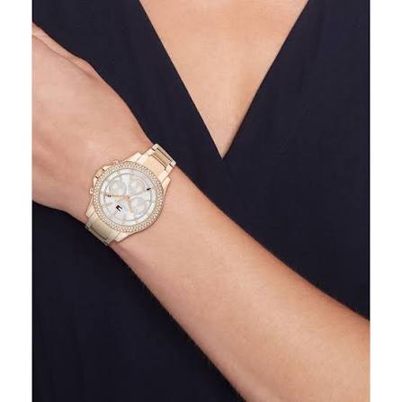 Rose gold women's chronograph watch worn on wrist against dark sleeve